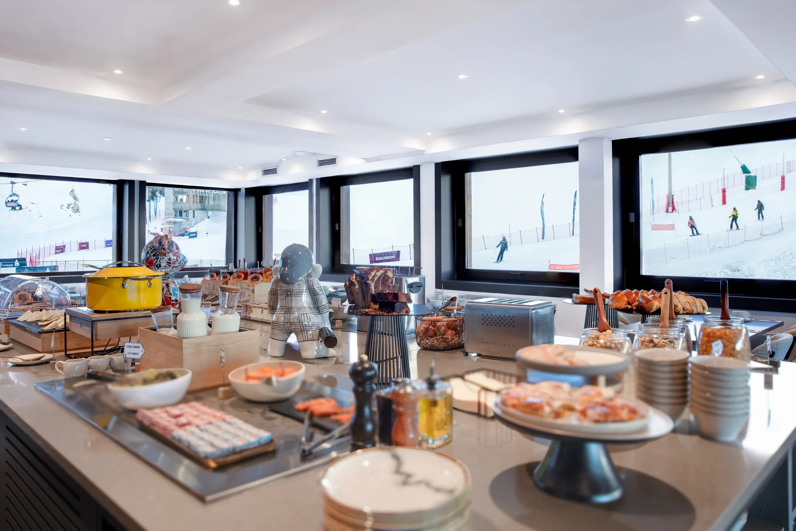 Buffet de petit-déjeuner avec vue sur pistes enneigées.